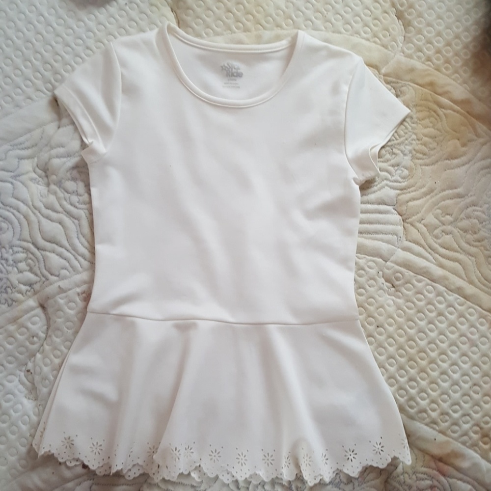 White lace see-through shirt has lakes at the bott